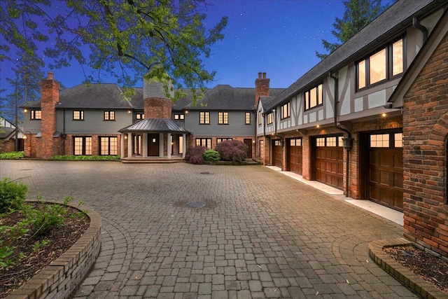 490 E Long Lake Rd, Bloomfield Hills, MI 48304 - view of front of home featuring driveway, a garage, brick siding, a chimney, and a gazebo