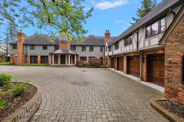 490 E Long Lake Rd, Bloomfield Hills, MI 48304 - view of front facade with curved driveway, a gazebo, an attached garage, and brick siding