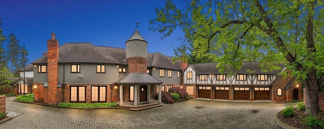 490 E Long Lake Rd, Bloomfield Hills, MI 48304 - view of front facade with curved driveway, a chimney, a garage, and brick siding