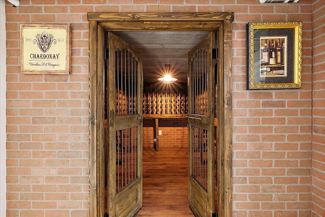 490 E Long Lake Rd, Bloomfield Hills, MI 48304 - wine room featuring wood finished floors and brick wall