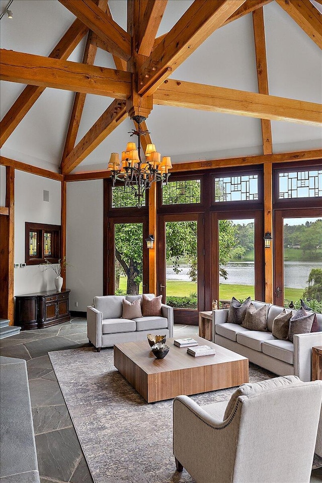 490 E Long Lake Rd, Bloomfield Hills, MI 48304 - living room featuring high vaulted ceiling, plenty of natural light, a chandelier, a water view, and stone tile floors