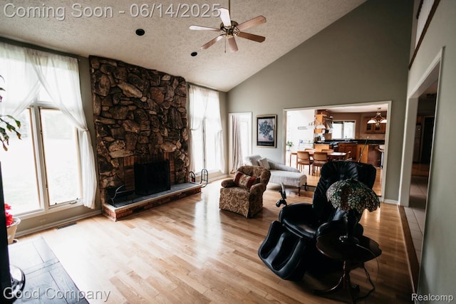 515 Oakbridge Dr, Rochester, MI 48306 - living area featuring a ceiling fan, high vaulted ceiling, wood finished floors, healthy amount of natural light, and a textured ceiling