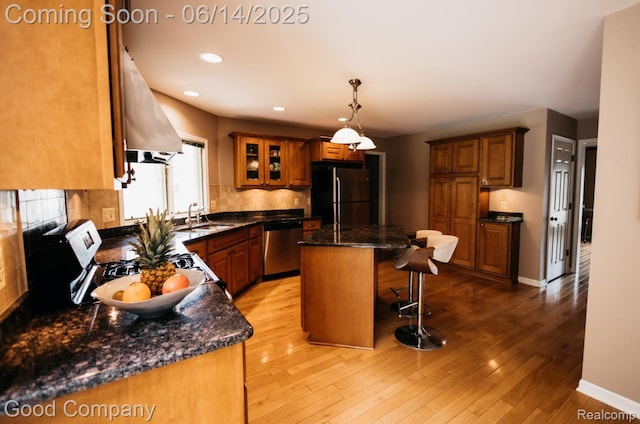515 Oakbridge Dr, Rochester, MI 48306 - kitchen with freestanding refrigerator, dishwasher, a breakfast bar, brown cabinets, and recessed lighting