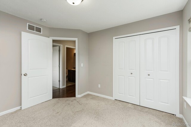 13135 River Rock Pass, Linden, MI 48451 - unfurnished bedroom featuring carpet flooring, baseboards, and a closet