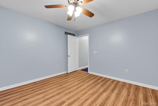 32051 W Cranston St, New Haven, MI 48048 - unfurnished room featuring baseboards, light wood-style floors, and a ceiling fan