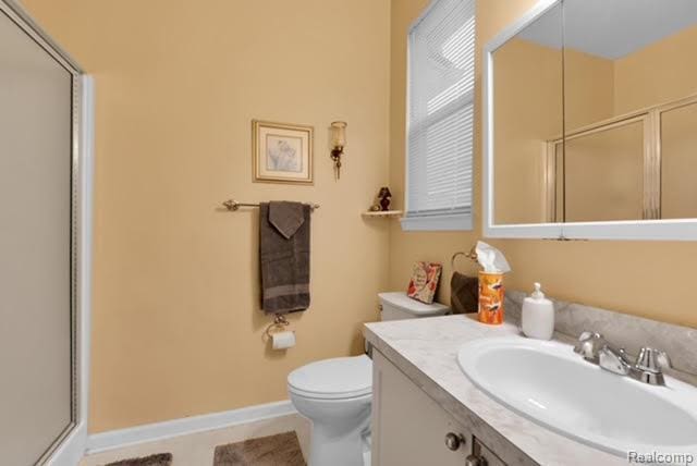 32051 W Cranston St, New Haven, MI 48048 - bathroom with an enclosed shower, toilet, vanity, and tile patterned flooring