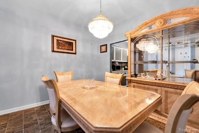 32051 W Cranston St, New Haven, MI 48048 - dining area featuring baseboards and a chandelier