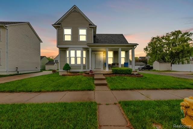 32051 W Cranston St, New Haven, MI 48048 - traditional-style home with covered porch and a front lawn
