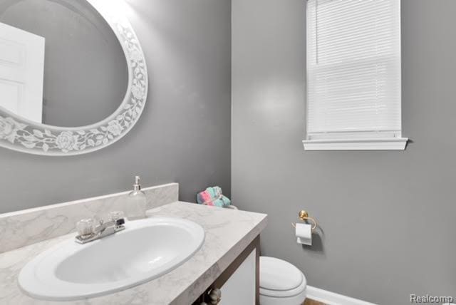 32051 W Cranston St, New Haven, MI 48048 - bathroom featuring vanity, toilet, and baseboards