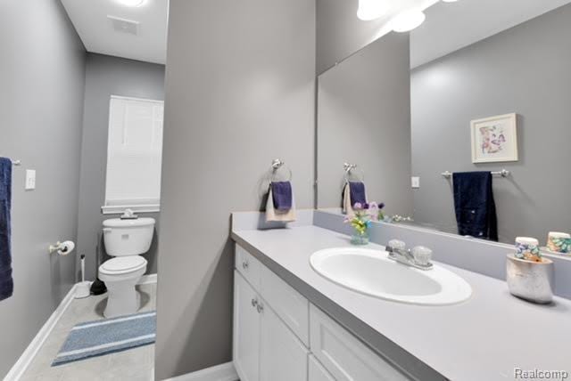 32051 W Cranston St, New Haven, MI 48048 - bathroom featuring baseboards, vanity, toilet, and tile patterned flooring