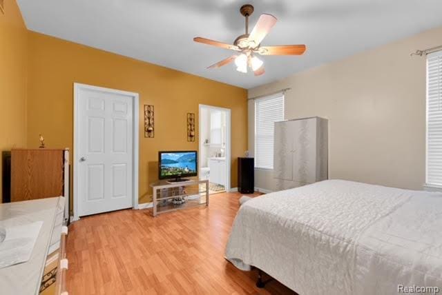 32051 W Cranston St, New Haven, MI 48048 - bedroom featuring light wood-style floors, multiple windows, and ceiling fan