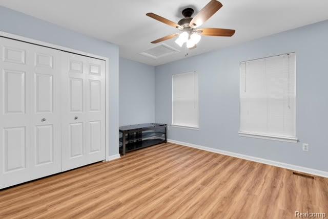 32051 W Cranston St, New Haven, MI 48048 - unfurnished bedroom featuring light wood-style floors, baseboards, a closet, and ceiling fan