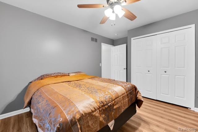 32051 W Cranston St, New Haven, MI 48048 - bedroom with wood finished floors, a closet, baseboards, and a ceiling fan