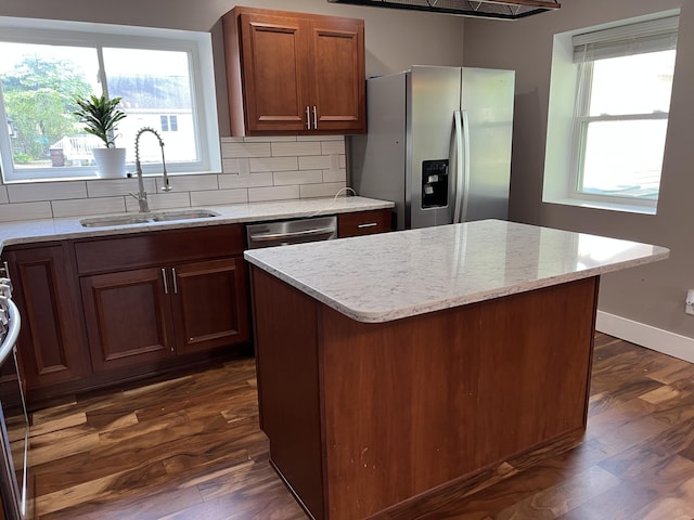 1302 Barnes St, Albion, MI 49224 - kitchen featuring appliances with stainless steel finishes, a sink, dark wood finished floors, backsplash, and light stone counters