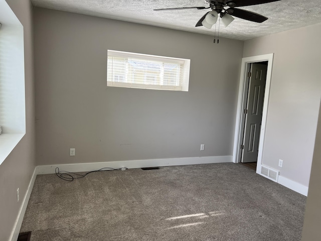1302 Barnes St, Albion, MI 49224 - carpeted spare room featuring a ceiling fan, a textured ceiling, and baseboards