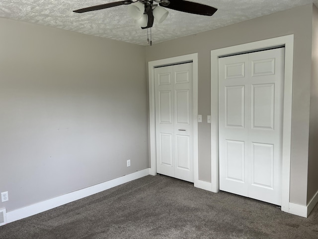 1302 Barnes St, Albion, MI 49224 - unfurnished bedroom with dark carpet, a textured ceiling, baseboards, and ceiling fan