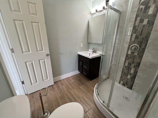1302 Barnes St, Albion, MI 49224 - full bath with toilet, a shower stall, vanity, wood finished floors, and baseboards