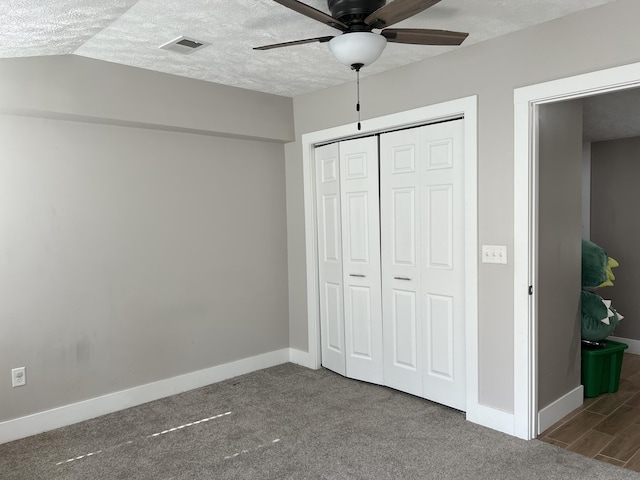 1302 Barnes St, Albion, MI 49224 - unfurnished bedroom featuring a closet, a textured ceiling, baseboards, ceiling fan, and carpet floors