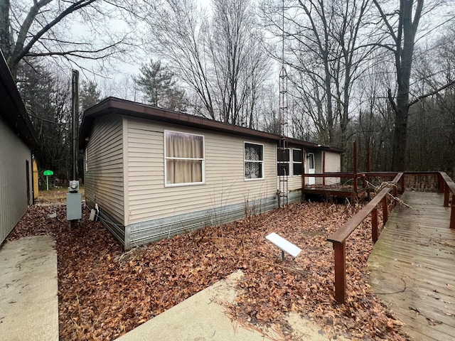 10750 16 Mile Rd NE, Cedar Springs, MI 49319 - view of side of home featuring a wooden deck