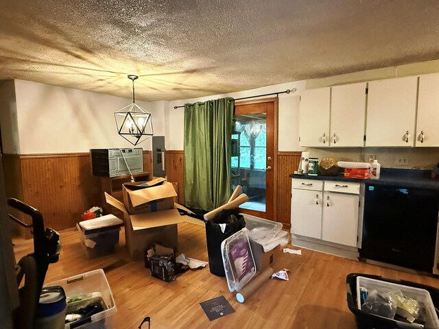 10750 16 Mile Rd NE, Cedar Springs, MI 49319 - dining area featuring wainscoting, a textured ceiling, light wood finished floors, wood walls, and electric panel