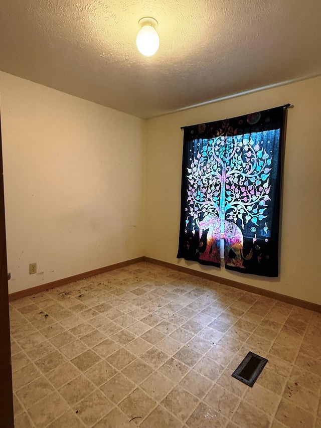 10750 16 Mile Rd NE, Cedar Springs, MI 49319 - unfurnished room featuring a textured ceiling and baseboards