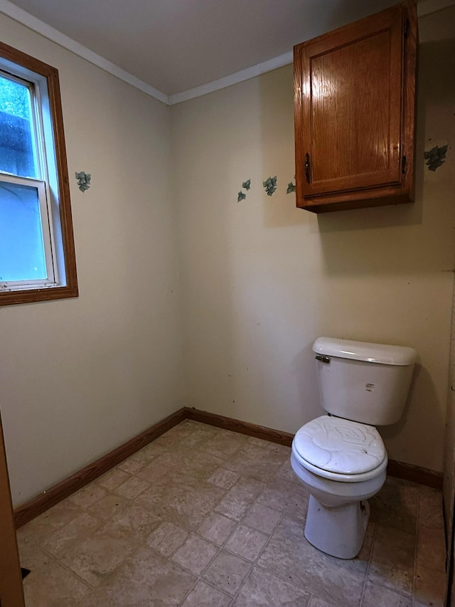 10750 16 Mile Rd NE, Cedar Springs, MI 49319 - bathroom featuring toilet, baseboards, ornamental molding, and stone finish flooring