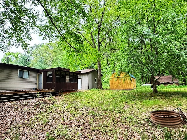 10750 16 Mile Rd NE, Cedar Springs, MI 49319 - view of yard with a sunroom and an outdoor fire pit