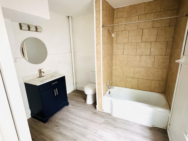 2513 5th St, Muskegon, MI 49444 - full bath featuring vanity, toilet, wood finished floors, and washtub / shower combination