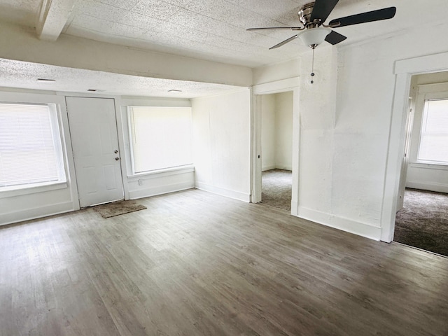 2513 5th St, Muskegon, MI 49444 - unfurnished living room with wood finished floors, ceiling fan, and baseboards