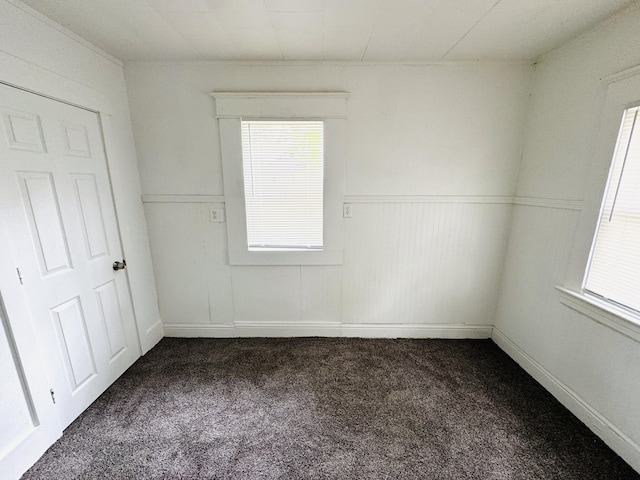 2513 5th St, Muskegon, MI 49444 - spare room with dark carpet and wainscoting