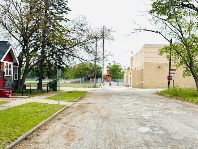 2513 5th St, Muskegon, MI 49444 - view of asphalt road featuring traffic signs and curbs