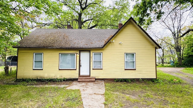 2513 5th St, Muskegon, MI 49444 - view of front of house with entry steps and a chimney