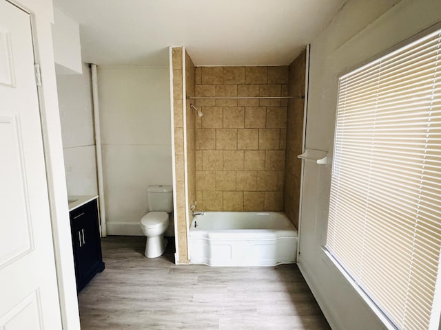 2513 5th St, Muskegon, MI 49444 - full bathroom featuring toilet, wood finished floors, vanity, and  shower combination
