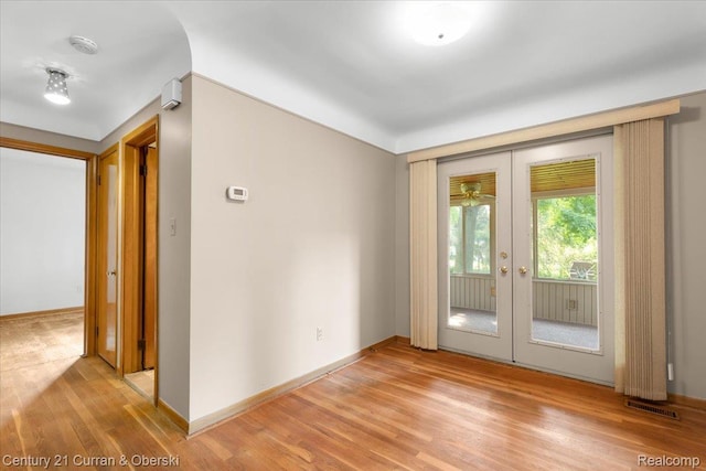 3183 Mildred St, Wayne, MI 48184 - empty room with french doors, light wood-style flooring, a smoke detector, and baseboards