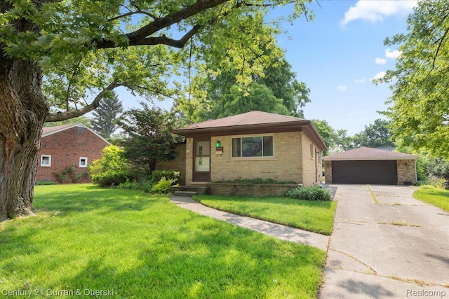 3183 Mildred St, Wayne, MI 48184 - view of front of house featuring brick siding, a detached garage, a front yard, and an outbuilding