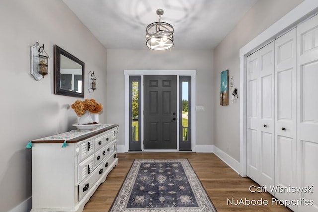 3732 E 128th St, Grant, MI 49327 - entryway featuring wood finished floors, baseboards, and a chandelier