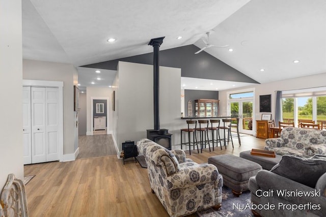 3732 E 128th St, Grant, MI 49327 - living room featuring a wood stove, ceiling fan, wood finished floors, high vaulted ceiling, and recessed lighting