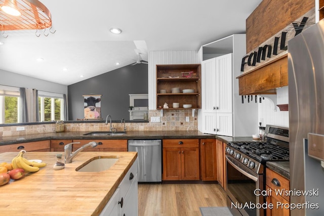 3732 E 128th St, Grant, MI 49327 - kitchen with appliances with stainless steel finishes, a sink, wooden counters, light wood-type flooring, and lofted ceiling