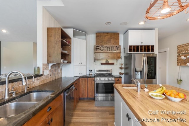 3732 E 128th St, Grant, MI 49327 - kitchen with open shelves, stainless steel appliances, a sink, wood finished floors, and recessed lighting