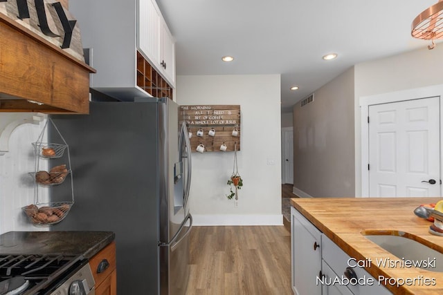 3732 E 128th St, Grant, MI 49327 - kitchen with wood counters, a sink, wood finished floors, recessed lighting, and baseboards
