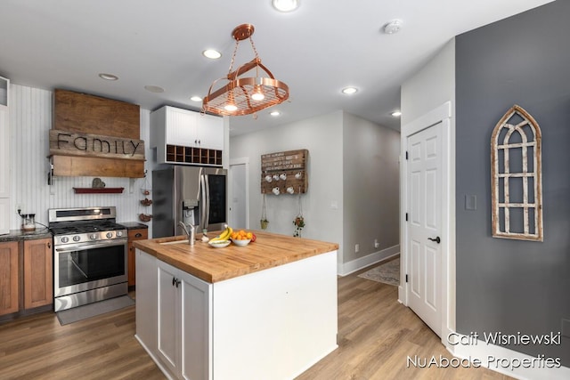 3732 E 128th St, Grant, MI 49327 - kitchen featuring appliances with stainless steel finishes, wood counters, open shelves, recessed lighting, and light wood-type flooring