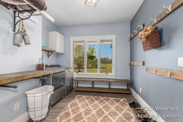 3732 E 128th St, Grant, MI 49327 - washroom featuring washing machine and dryer, cabinet space, wood finished floors, and baseboards