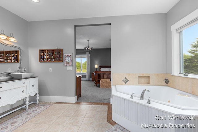 3732 E 128th St, Grant, MI 49327 - bathroom featuring vanity, a jetted tub, plenty of natural light, and baseboards