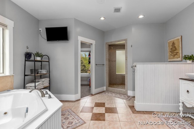 3732 E 128th St, Grant, MI 49327 - bathroom featuring a shower stall, a jetted tub, baseboards, tile patterned flooring, and vanity
