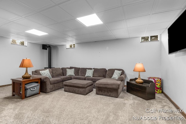 3732 E 128th St, Grant, MI 49327 - living room featuring carpet, a wood stove, and baseboards