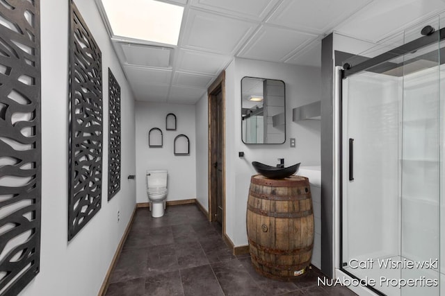 3732 E 128th St, Grant, MI 49327 - full bathroom featuring baseboards, a stall shower, toilet, and vanity