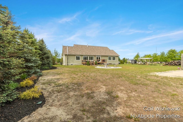 3732 E 128th St, Grant, MI 49327 - view of front of house featuring a front lawn, a wooden deck, and a patio