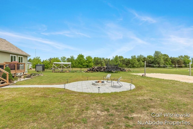 3732 E 128th St, Grant, MI 49327 - view of grassy yard featuring a fire pit and volleyball court