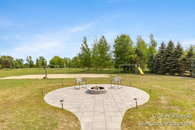 3732 E 128th St, Grant, MI 49327 - view of patio / terrace with volleyball court, a fire pit, and a playground