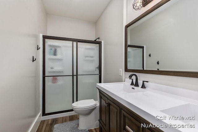 3732 E 128th St, Grant, MI 49327 - full bathroom with wood finished floors, toilet, a shower stall, and vanity